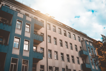 yellow and blue colored house with small lensflare on the top