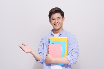 Confident asian handsome student holding books  gesture hand