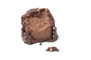 closeup of broken milk chocolate in shaped rock on white background