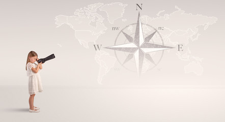 Little girl looking through spyglass to map and compass concept     © ra2 studio