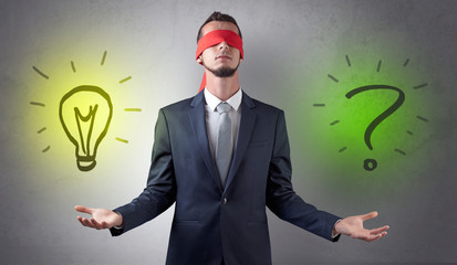 Covered eye businessman with bulb and question sign symbols around