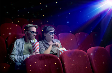 Naklejka premium Lovely couple watching 3D movie with little sparkling stars around