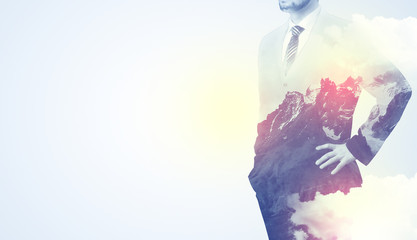 Businessman standing and thinking with snowy mountain graphic