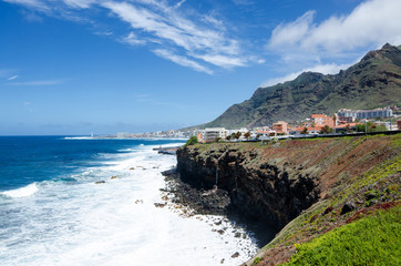 Beautiful landscape of the Tenerife North. View of the rural park Anaga mountains, atlantic ocean, steep banks, big waves and villages of Bajamar and Punta Del Hidalgo. Tenerife, Canary Islands, Spain