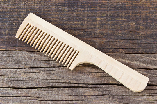 Comb on wooden background