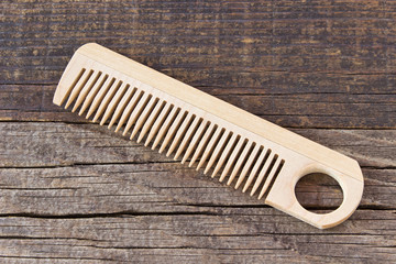 Comb on wooden background
