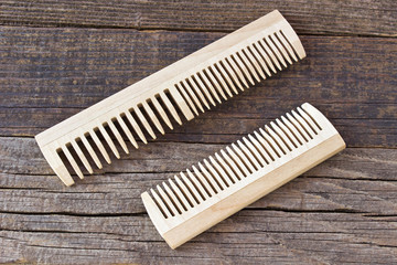 Combs on wooden background
