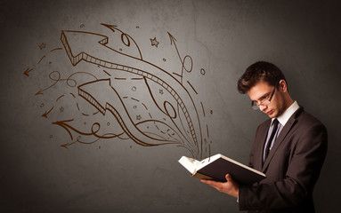 Casual young man holding book with brown arrows and stars flying out of it