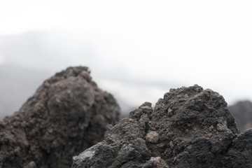 Detail of the dark land of the slopes of the mount Etna. An active volcano in Sicily Etna. People hike up this famous place to see this unusual landscape.