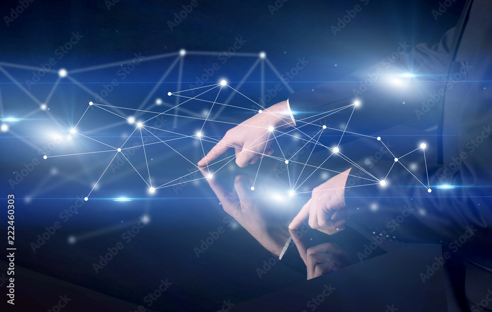 Poster male hands touching interactive table with blue connectivity graphic in the background