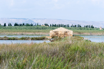 Beautiful mediterranean landscape in the natural reserve of Vendicari. A gorgeous and peaceful place in Sicily (Italy) near Syracuse. In this shot there is a water pond where many bird species live