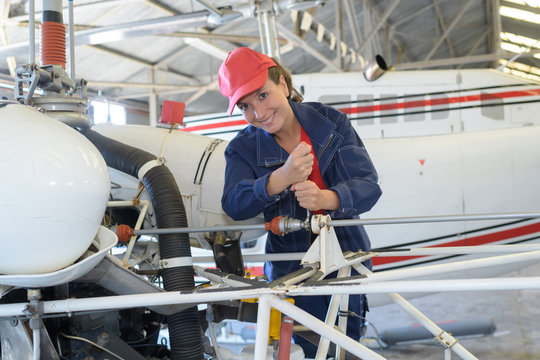 Female mechanic working on aircraft