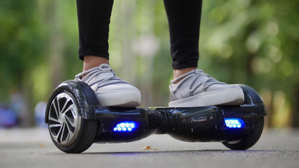 Female legs in sneakers on the steep gyrometer. Riding in the park. © KONSTANTIN SHISHKIN