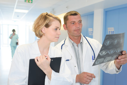 male and female doctor checking xray at work