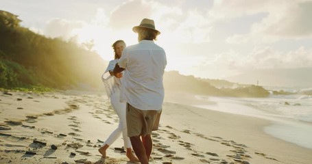 Romantic middle age couple holding hands enjoying life together, young at heart