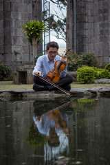 violinist on the shore of a lake