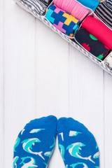 Feet selfie and a socks organizer on a white background. Top view, free space