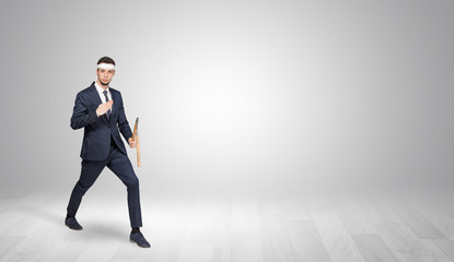 Young businessman in suit fighting in an empty space
