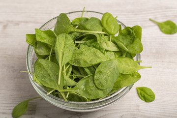 Fresh spinach leaves in a glass bowl