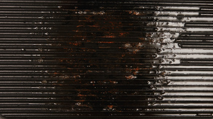 TOP VIEW: Used oil on a black grill