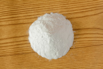 baking soda or baking powder in wooden background for cooking recipe or cleaning
