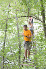 Naklejka na ściany i meble family climbing rope at the adventure park