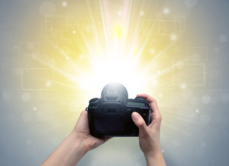Naked hand taking picture with digital camera and glowing flash concept

