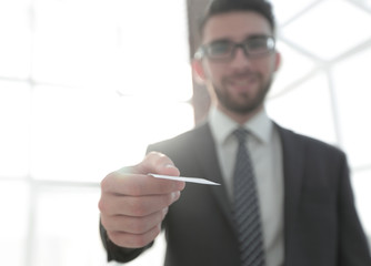 Business man giving business card on bright background