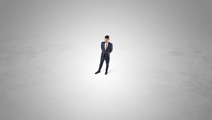 Obraz premium Young businessman standing alone in the middle of an empty space 