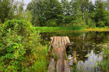 Wooden bridge at a quiet, small river