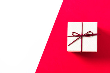 White gift box on red and white background. Copyspace


