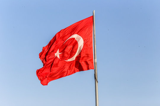 Turkish flag on a background of blue sky close-up
