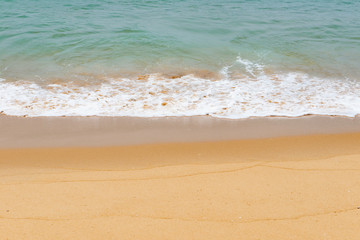 Fototapeta na wymiar soft wave of an ocean on a sandy beach