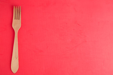 wooden fork in color background
