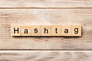 hashtag word written on wood block. hashtag text on table, concept