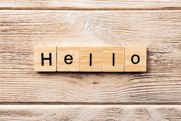 hello word written on wood block. hello text on table, concept