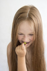 on white background girl eating grape hand feeding