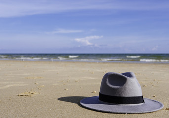 Fototapeta na wymiar Beautiful women's hat on the beach during summer.