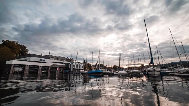 Point of view sailing a boat in a port, Velden Am Worthersee lake, Austria sky reflection sunset dusk 