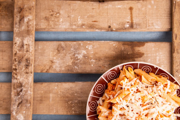 macaroni dish on wooden background