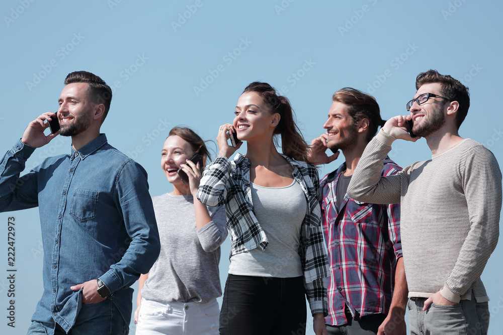 Wall mural closeup of a group of young people with smartphones.