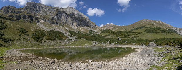 Fototapeta na wymiar panorama view mountain lake Krumpensee on Eisenerzer Reichenstein, a mountain in the Ennstal Alps in the Austrian federal state of Styria 