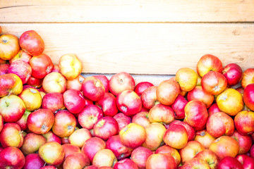 red ripe fall apples in wooden boxes at street market, retro toned