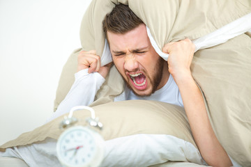 young angry man waking up