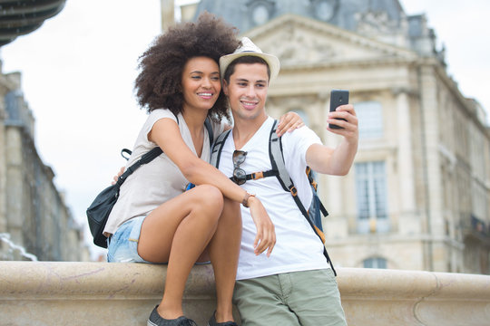 picture showing young couple taking selfie in the city