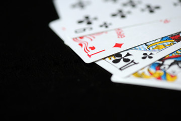 Playing cards on a dark background close up