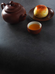 Mid-autumn festival is a traditional festival of East Asian culture and folk. Top view of mung bean pastry and Oolong tea on wooden background. With copy space.  Flat lay.  Taiwan food.