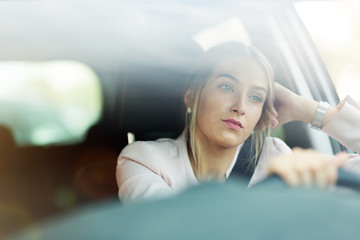 Young woman sitting in a car 
