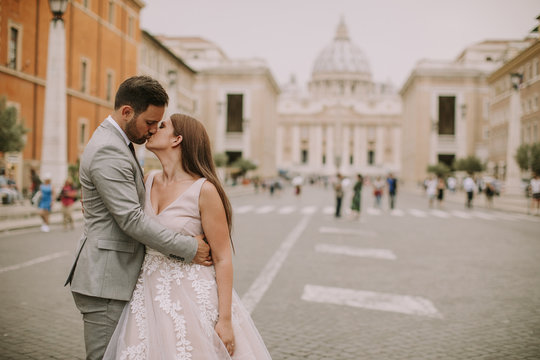 Young wedding couple by Saint Peter cathedral in Vatican