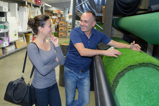 couple choosing grass in a store